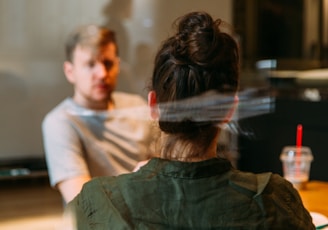 person sitting in a chair in front of a man