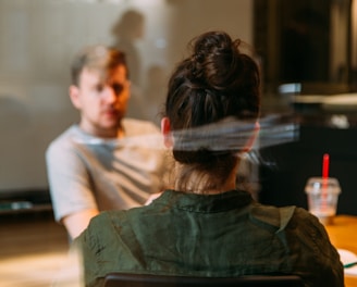 person sitting in a chair in front of a man