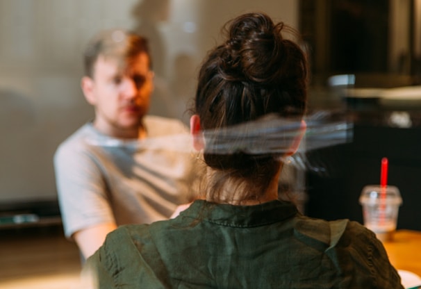 person sitting in a chair in front of a man