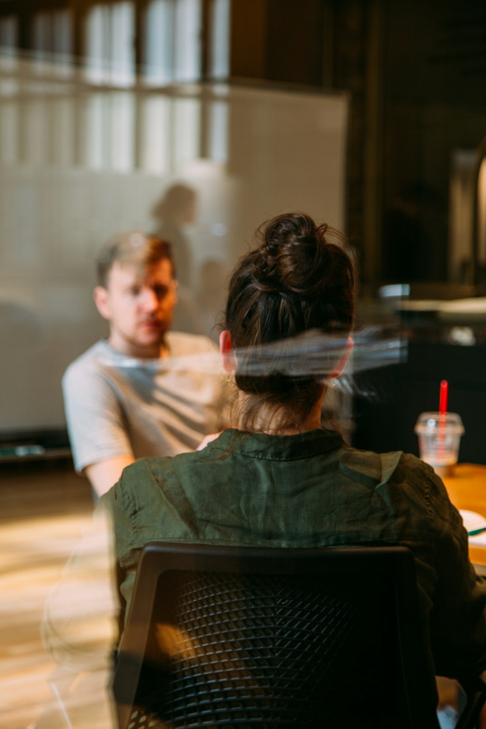Client sitting across from a business coach in a meeting