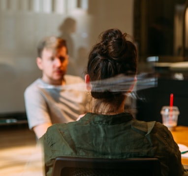 person sitting in a chair in front of a man