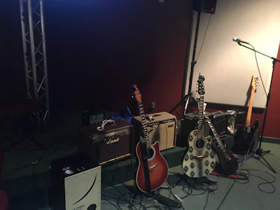 Cozy rehearsal room with guitar gear and warm lighting.