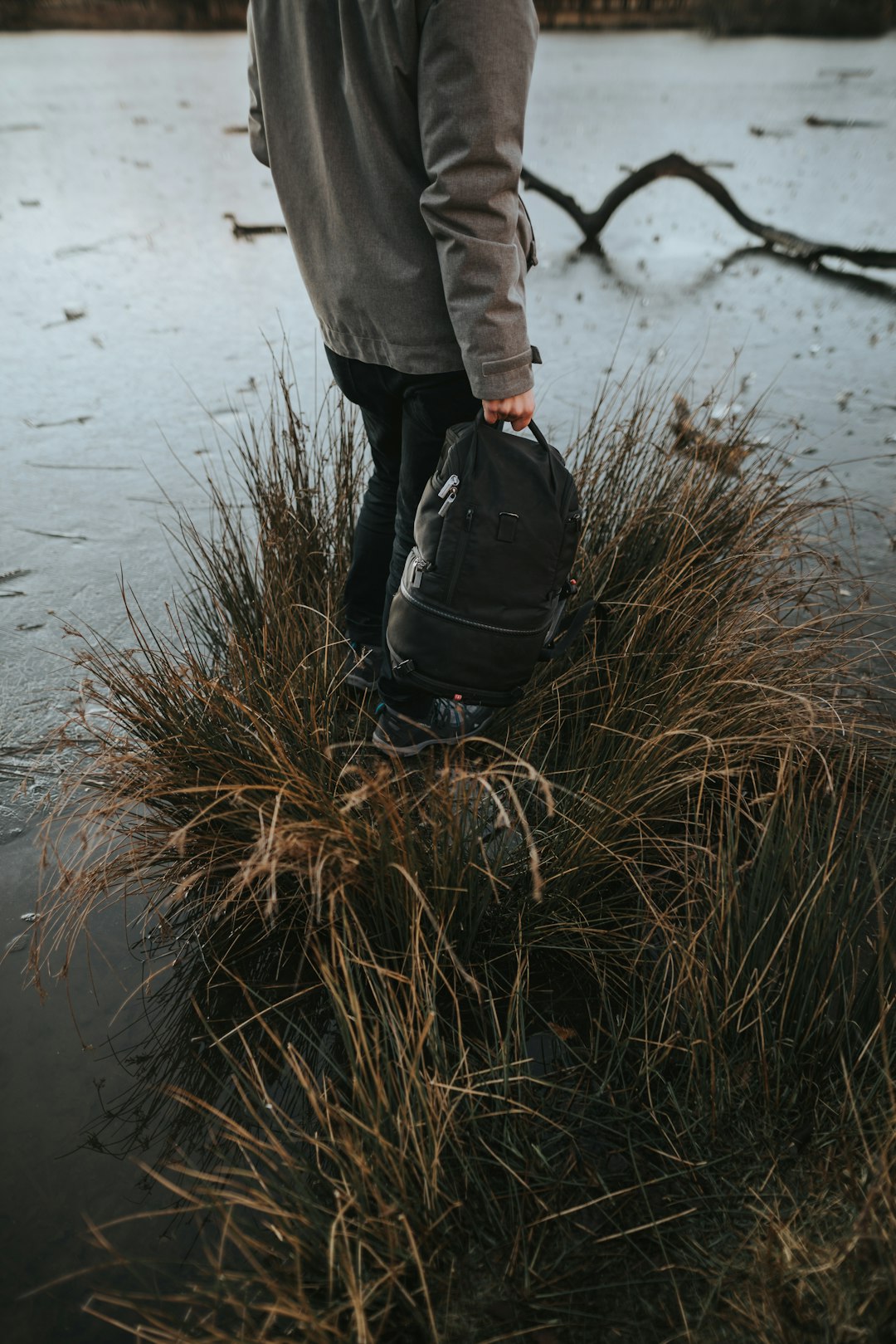 person carrying black backpack