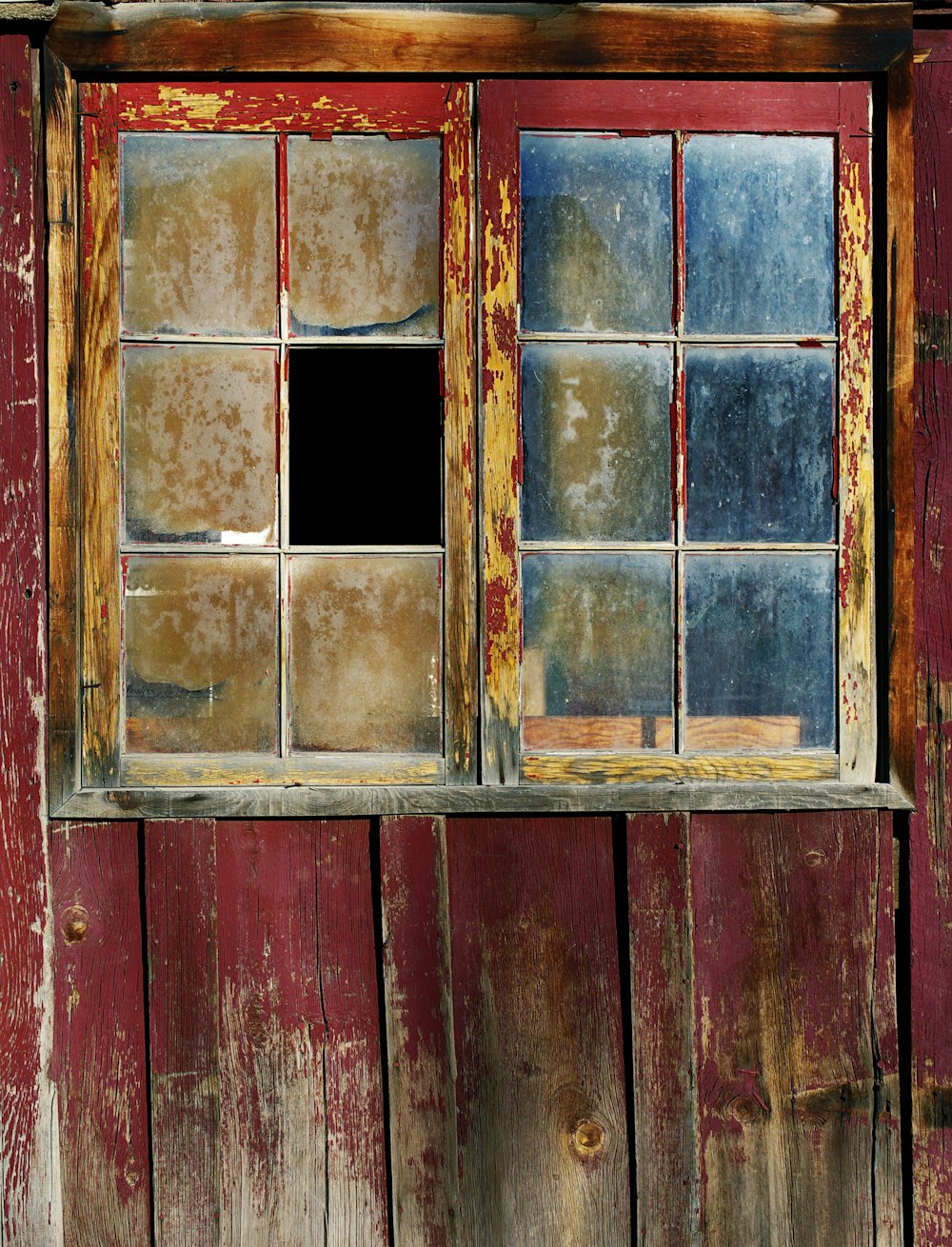 red wooden framed glass broken window