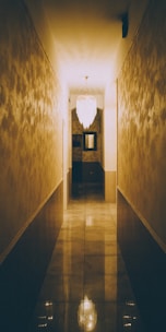 Glossy marble floor tiles reflecting soft natural light in a hallway.