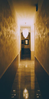 Glossy marble-effect tiles reflecting soft lighting in an elegant hallway