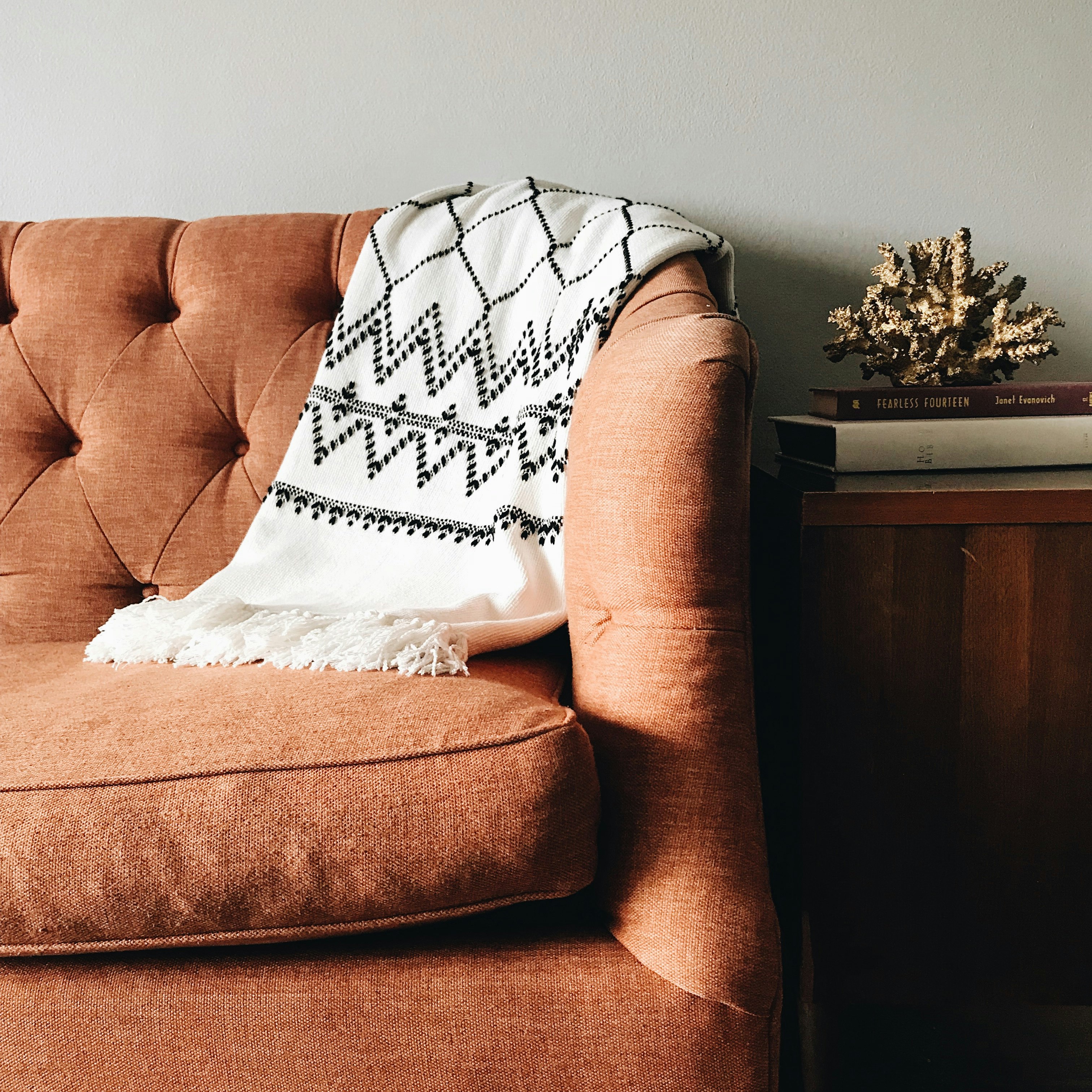 white and black textile on brown couch