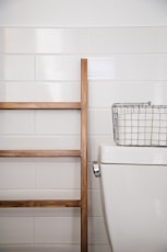 stainless steel basket on top white ceramic toilet bowl