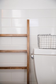 stainless steel basket on top white ceramic toilet bowl