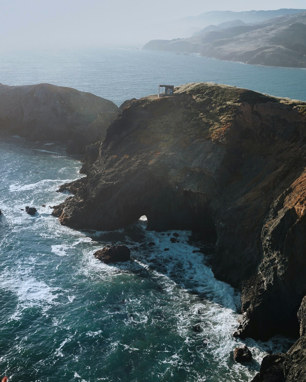 rock cliff near body of water