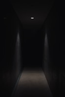 dark pathway lit with small light fixture