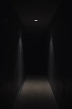 dark pathway lit with small light fixture
