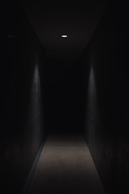 dark pathway lit with small light fixture