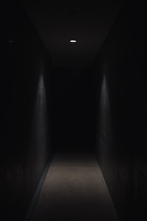 dark pathway lit with small light fixture