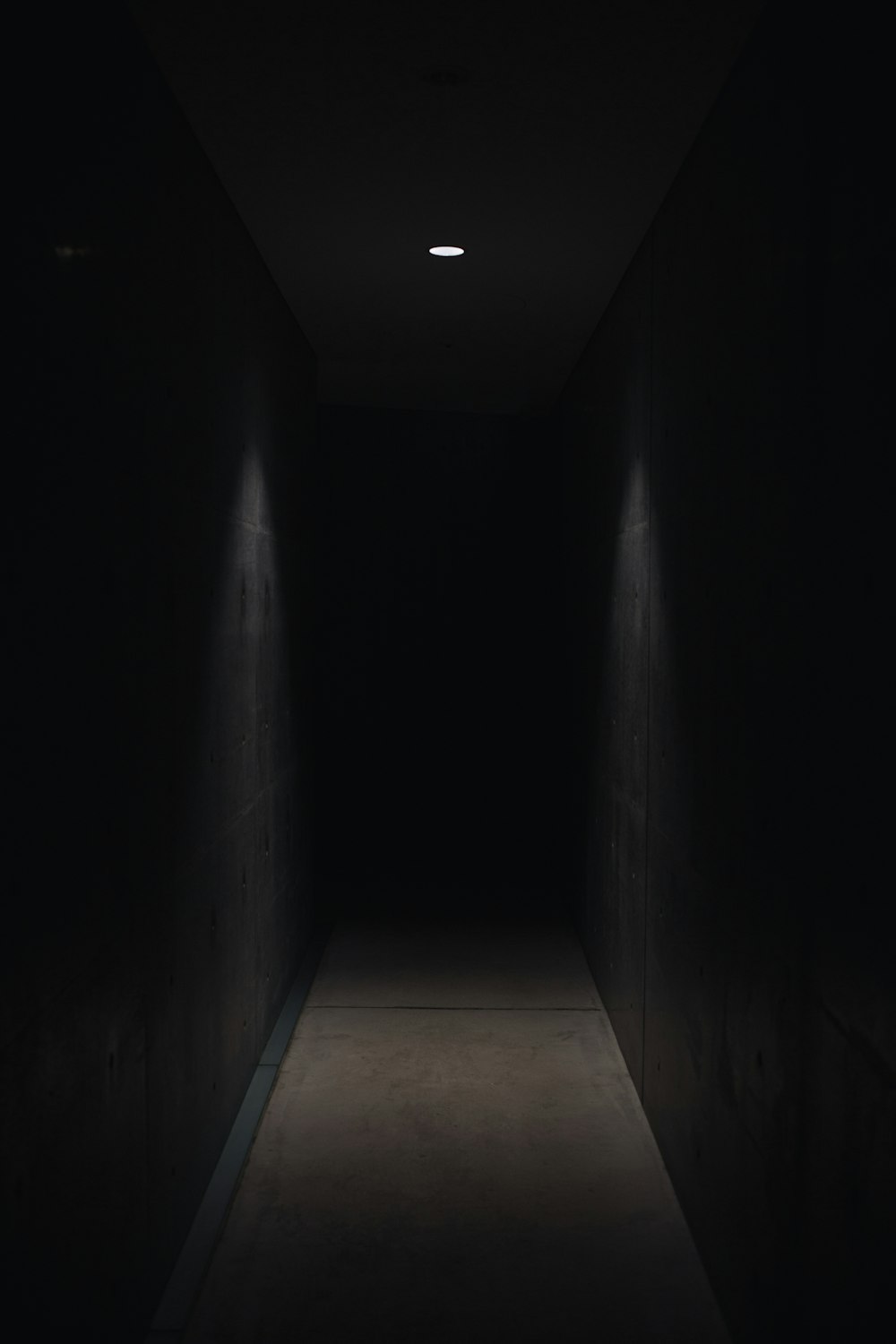 dark pathway lit with small light fixture