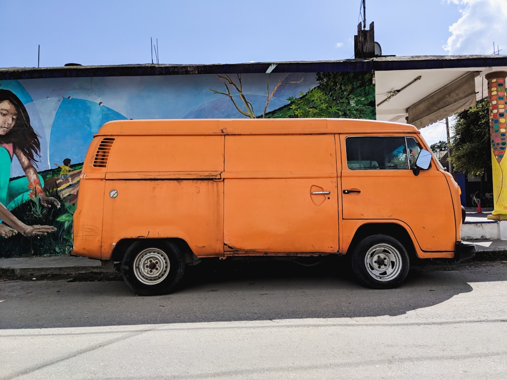 orange van parked beside house