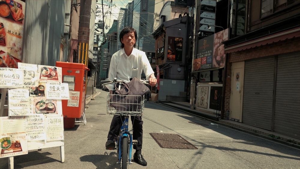 man riding blue bicycle