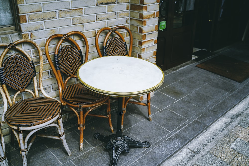 round white wooden table with three chairs