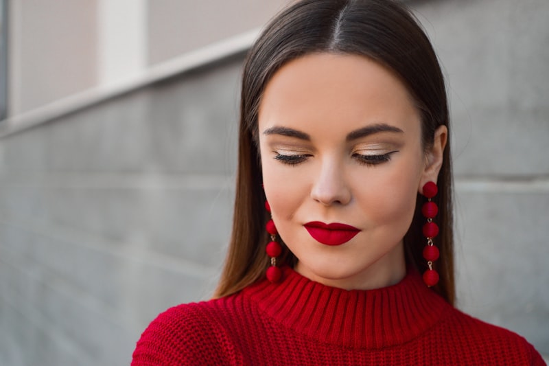 Woman in Red Sweater with red lipstick and red earrings