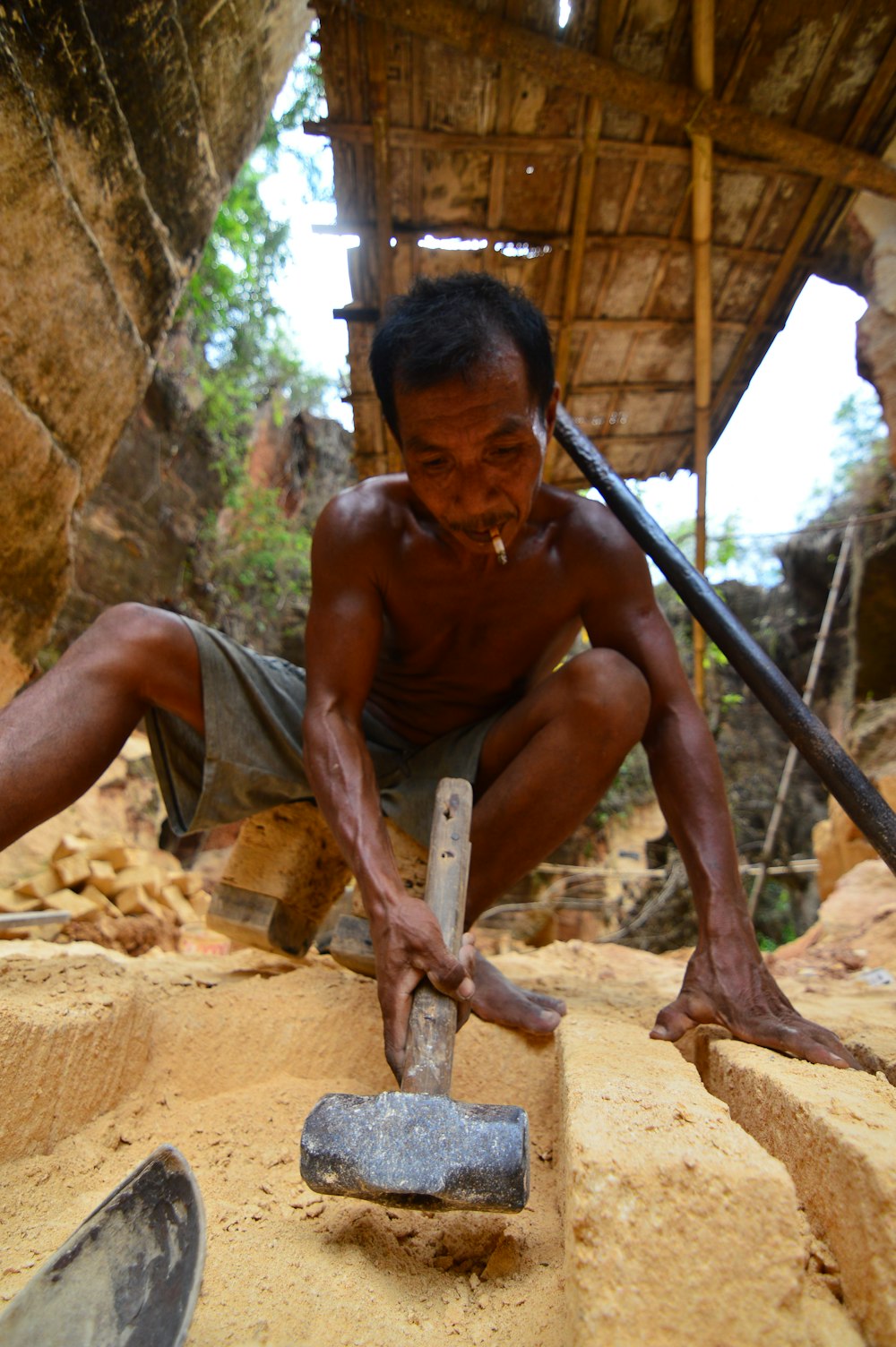 a man with a knife and a rock