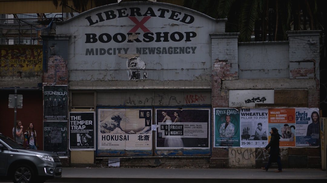 gray car in front of Liberated Bookshop sigange