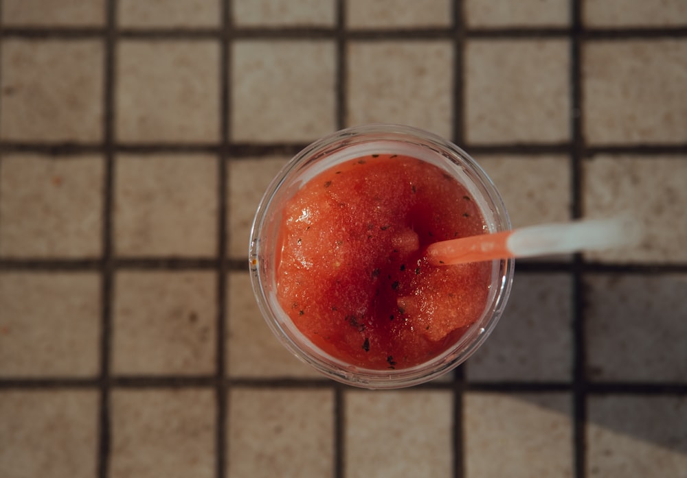 clear glass cup filled with red liquid