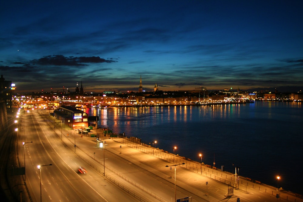 highway beside body of water at night