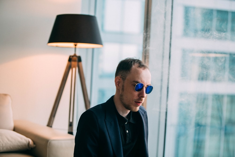 man wearing sunglasses near table lamp photo