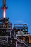 photography of black metal industrial factory