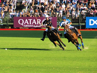 two person riding horse during daytime