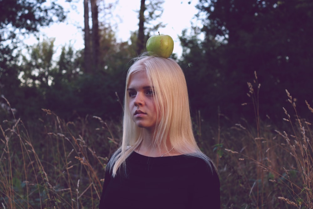 green apple on woman's head