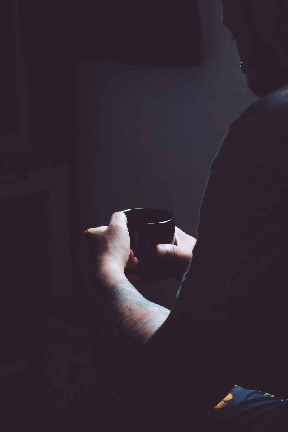 person holding black ceramic cup