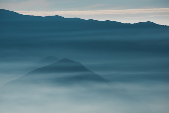 silhouette of foggy mountain in Giumello Italy