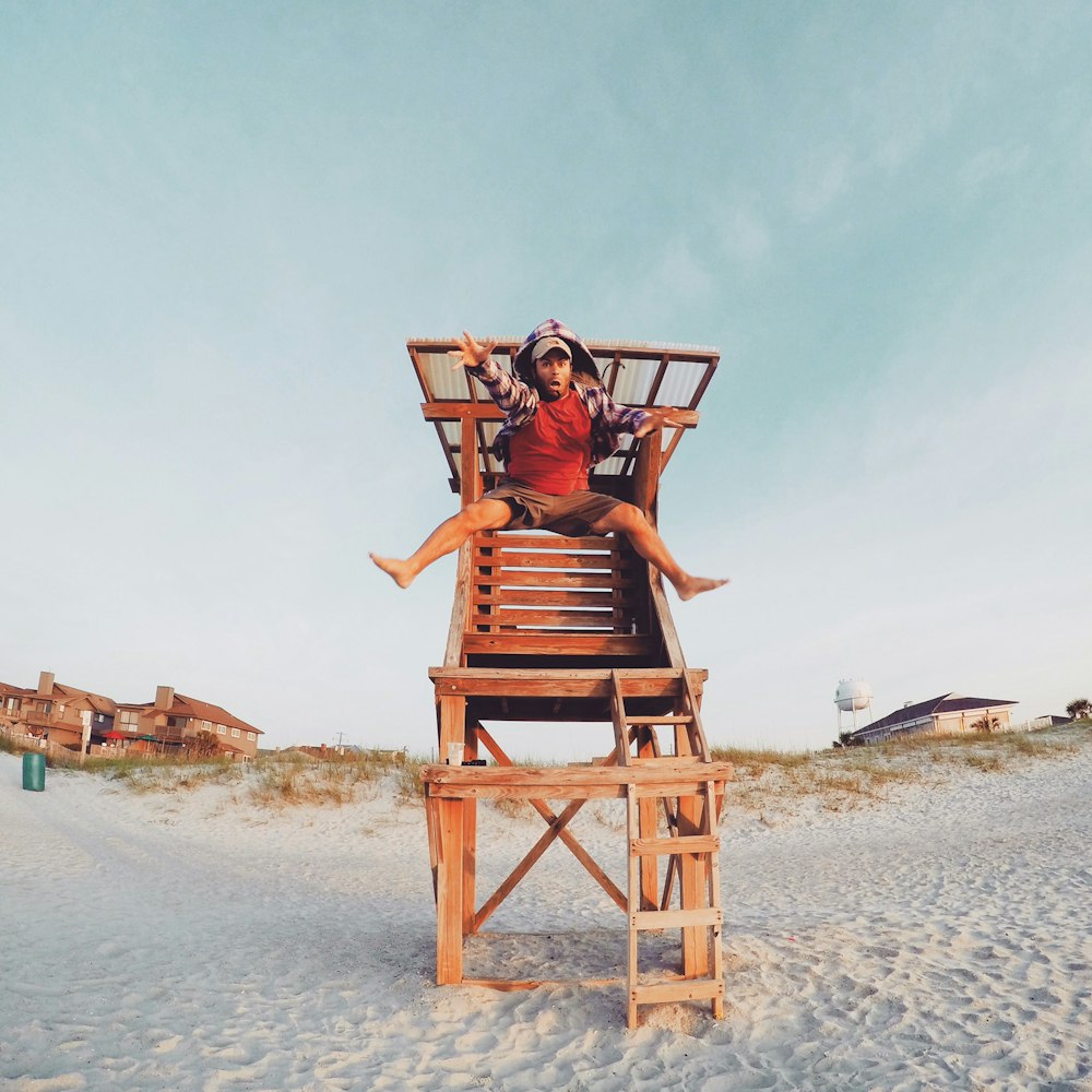 man jumping front the lifeguard post