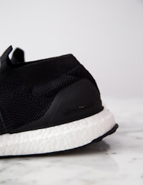 Close-up of Adidas Ultraboost sneakers with a street-style backdrop.