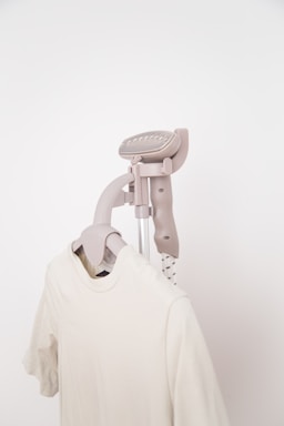An electric lint remover smoothing fabric on clothes.