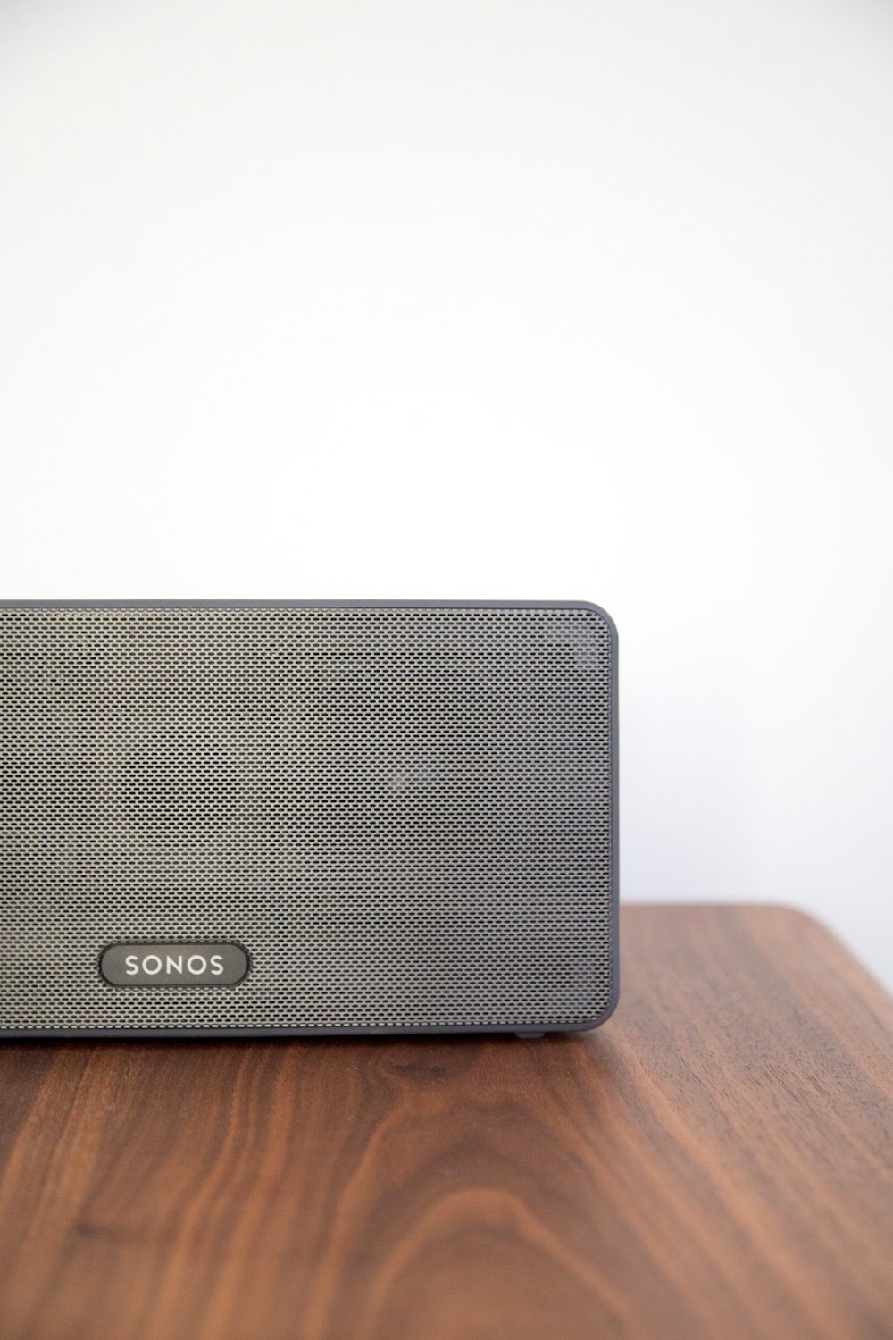 gray Sonos speaker on table