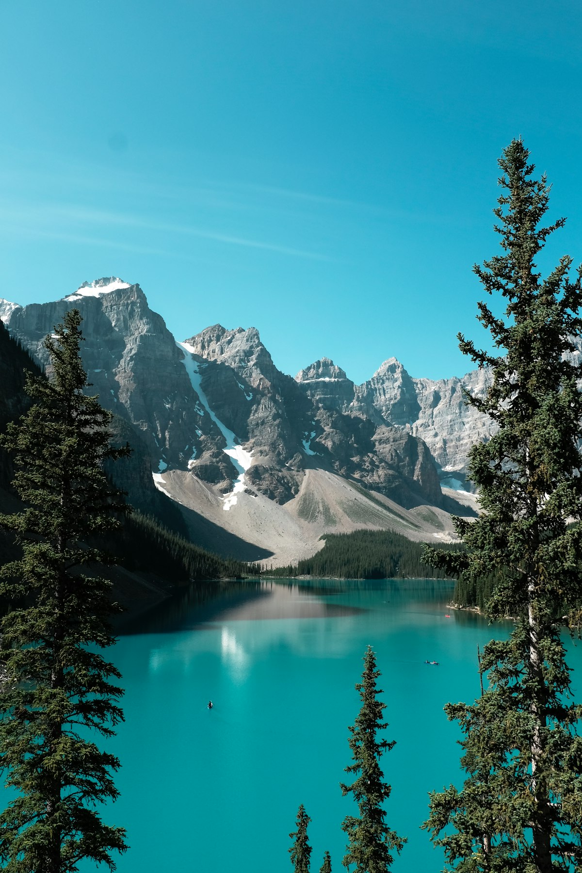 Lake Louise — turquoise lake with red canoes and Victoria Glacier in the distance