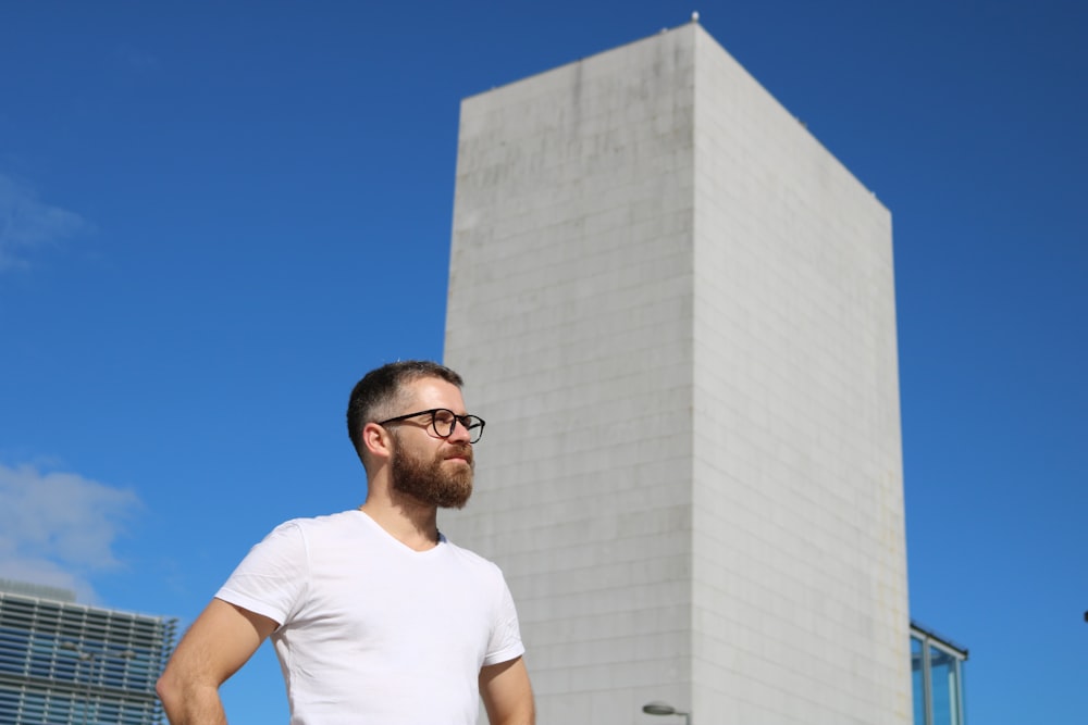 man stand near gray concrete post