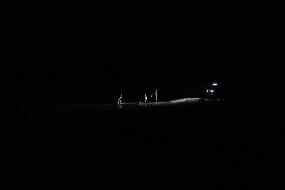 a truck driving down a dark road at night
