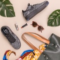 photo of bag, sneakers, and sunglasses on beige surface