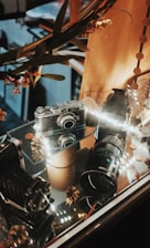 A cozy photo booth setup with warm lighting and vintage camera equipment.