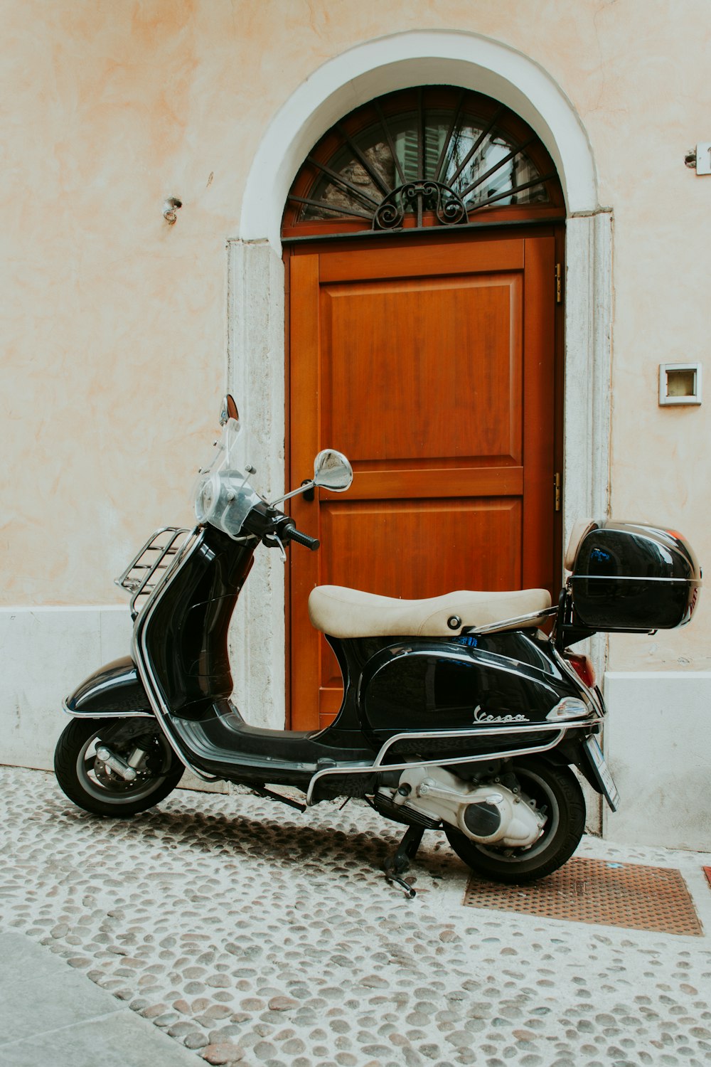 motor scooter parked near the door during day