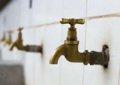 A professional shot of multiple water tap variants displayed on a showroom shelf.