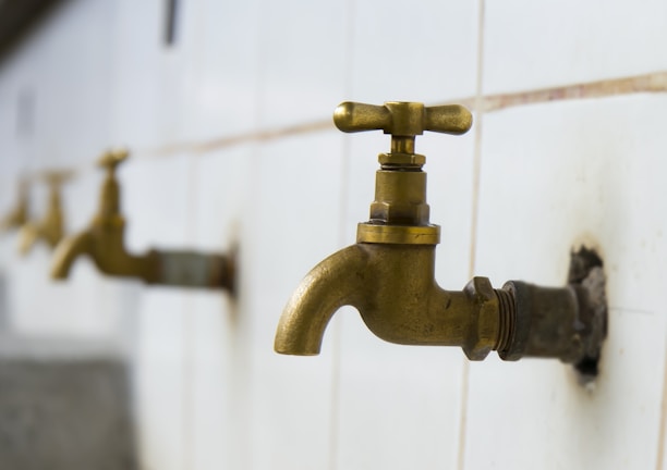 A close-up of plumbing installations in a newly built bathroom.
