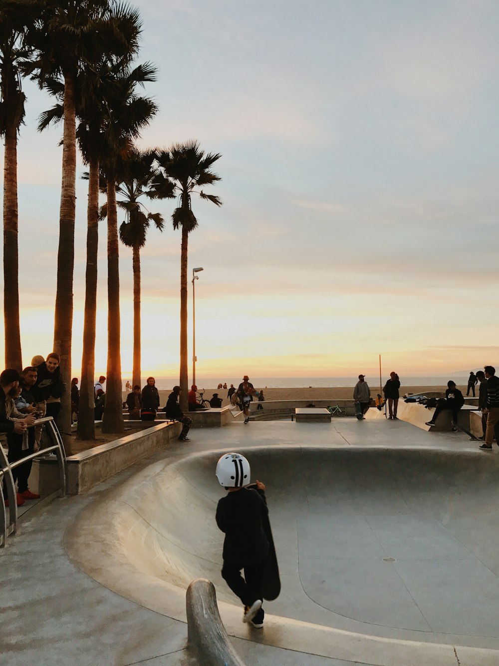 kid carrying black skateboard