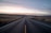 black concrete road between steppe