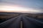 black concrete road between steppe