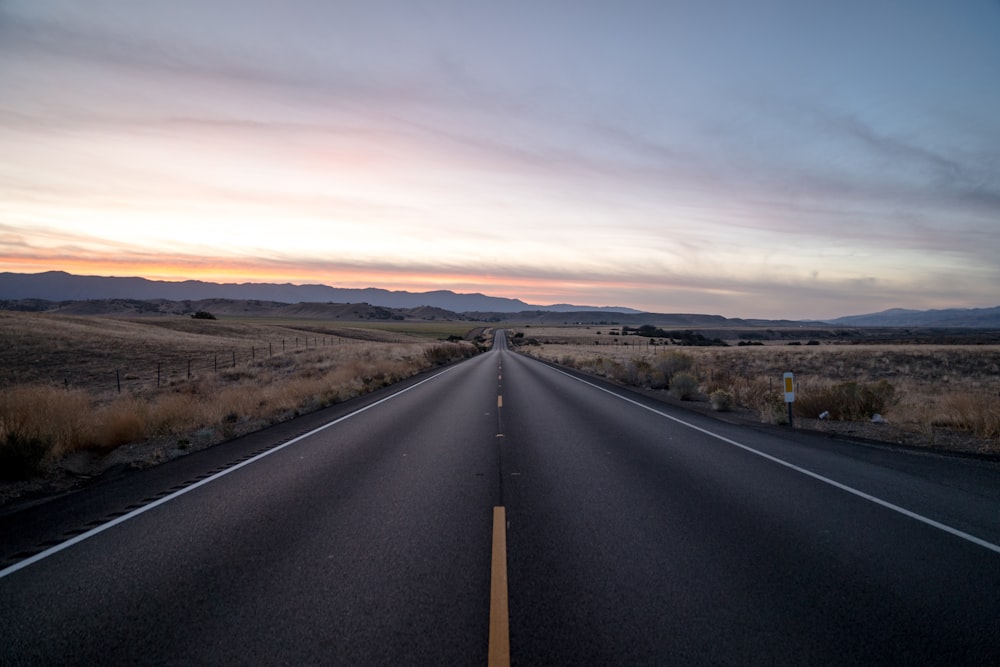 black concrete road between steppe