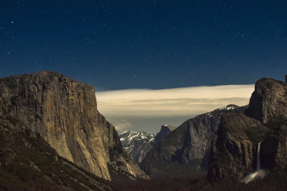 mountain ranges under cloudy sky